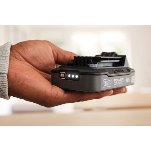 BLACKDECKER lithium battery BDL2018S with charge indicator, held in hand, side view.