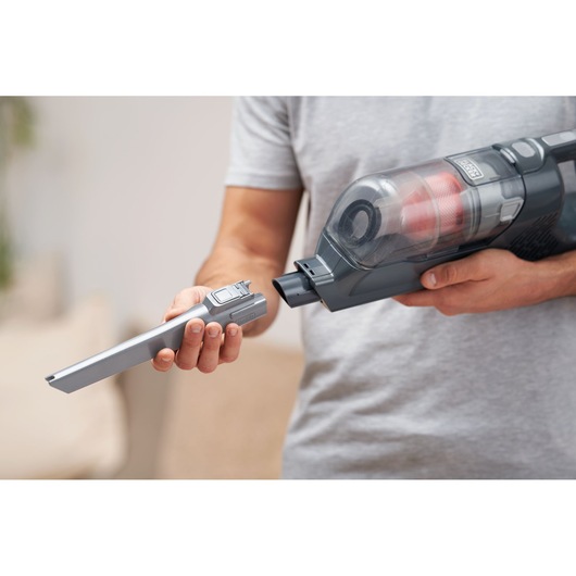 BLACKDECKER BHFEA515JB handheld vacuum cleaner with a detachable crevice tool being attached.