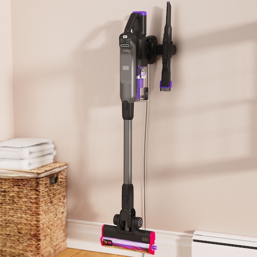 BLACKDECKER BHFEA640WG cordless stick vacuum in gray and purple mounted on wall in home setting.