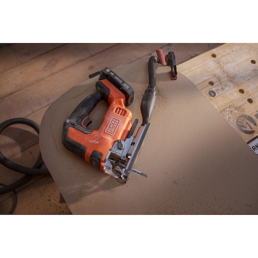 BLACK+DECKER BLCJS78N jigsaw with black handle on wooden floor, angled view, visible attached power cord.