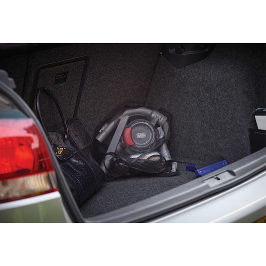 BLACKDECKER PD1200AV portable car vacuum in gray and red stored in vehicle trunk with accessories.