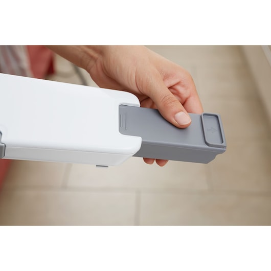 BLACKDECKER PV1820L vacuum cleaner, close-up of hand removing grey dust container.