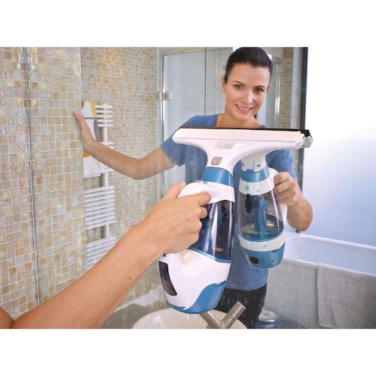 Photo of BLACK+DECKER WW100 window vacuum cleaner in use cleaning a bathroom mirror.