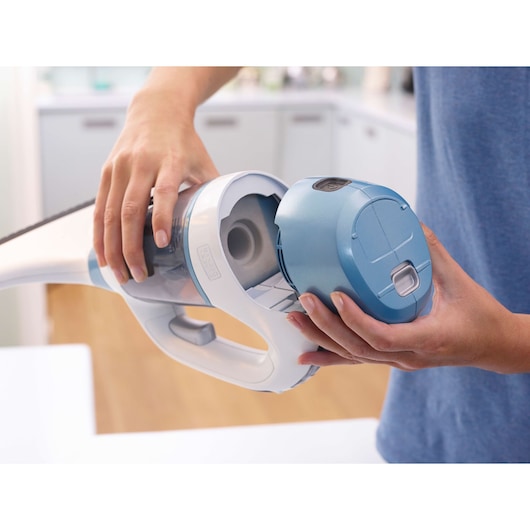 BLACKDECKER WW100 handheld vacuum in blue and white, filter compartment open in a kitchen setting